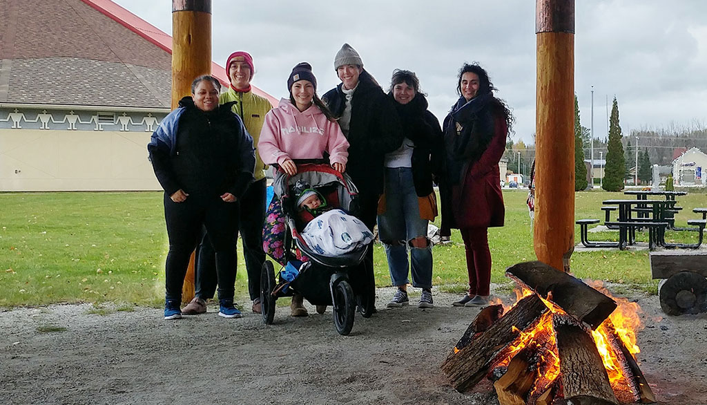 NACM members by the fire at the Kitigan Zibi Anishinabeg Cultural Centre