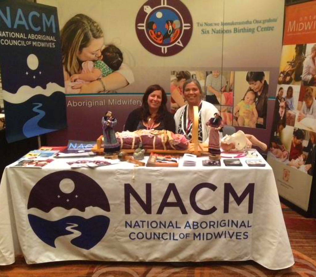 Indigenous midwives Ellen Blais and Laurie Jacobs at NACM booth at First Nations Health Managers Association conference in Niagara Falls, 2013