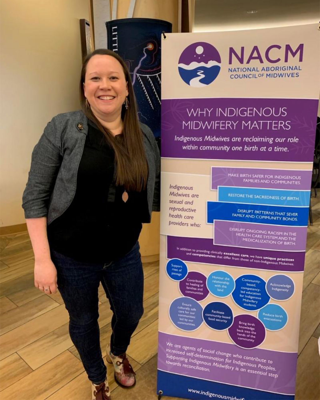 NACM Co‑Chair Claire Dion Fletcher with a banner produced for NACM by Inter Pares.